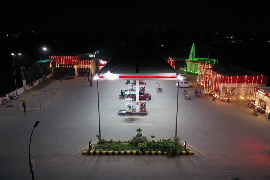 Lucky Petroleum forecourt lit up at night, seen from above